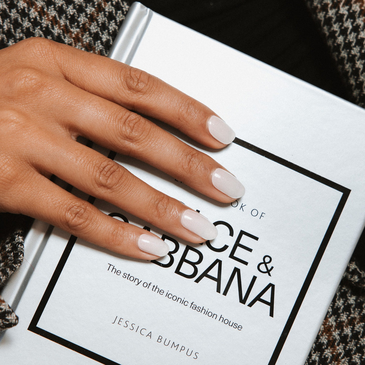 Hand with Babyboom Glitter gel nail stickers by Maniac Nails on a fashion book, easy salon quality gel nails at home