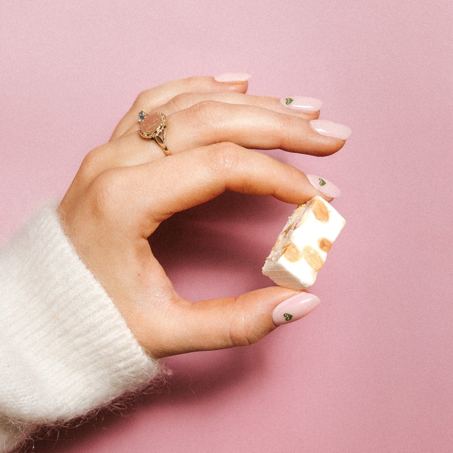 Minimal Crush Maniac Nails Light pink with green heart nail art on hand with candy and ring