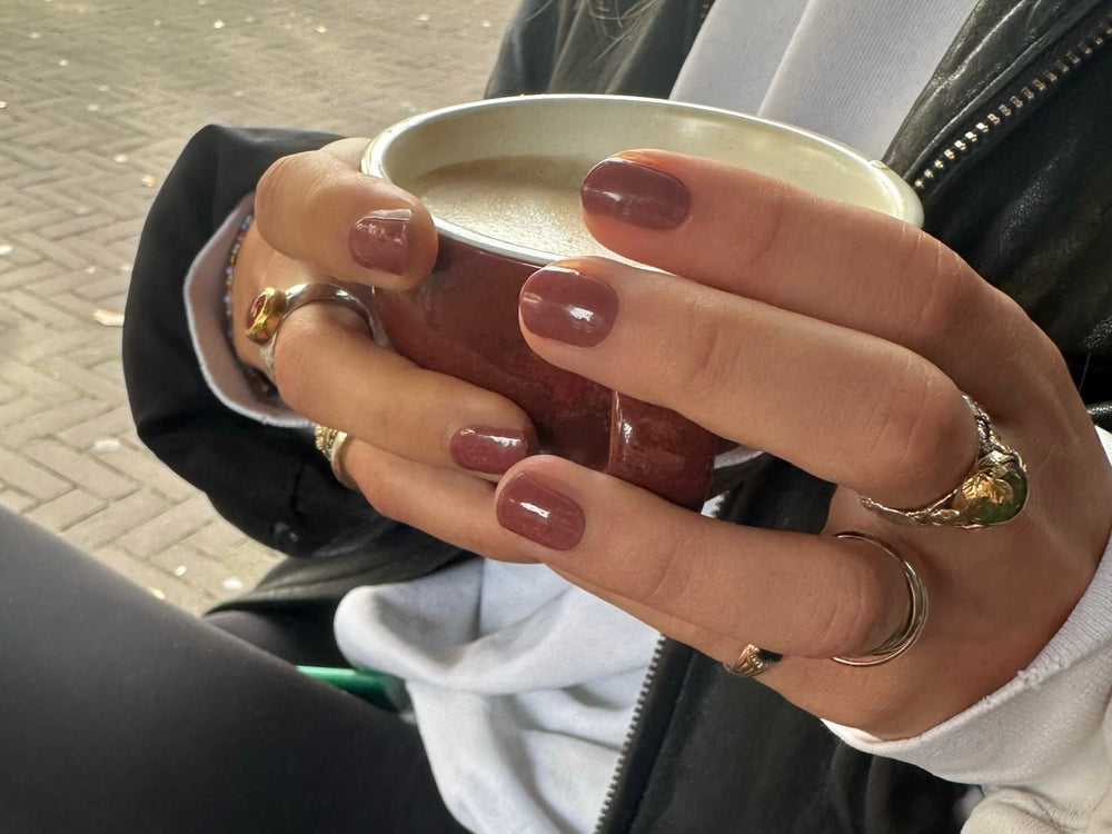 Bailey brown maniac gel manicure holding a coffee cup
