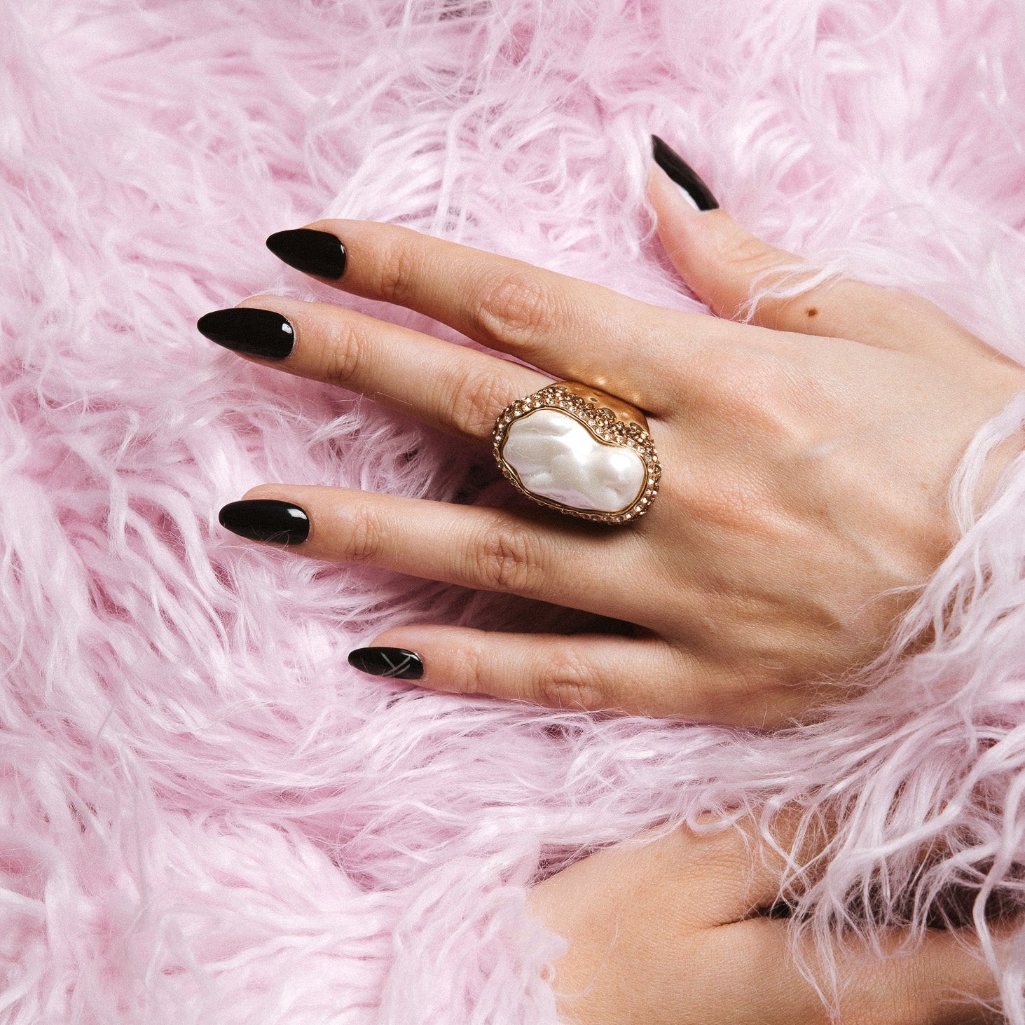 Bowie black Maniac nails gel stickers on hand with pearl ring and pink furry jacket 