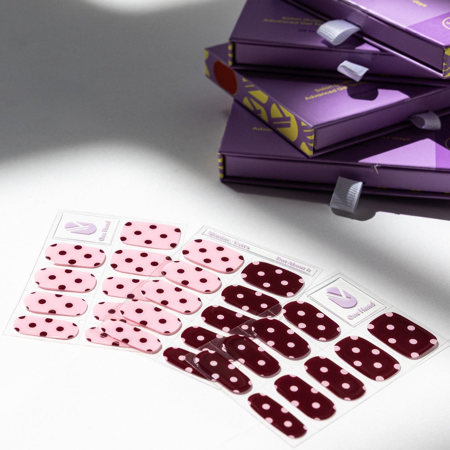 Dot About It gel nail sticker sheets by Maniac Nails, pink and bordeaux polka dot nail wraps and packaging