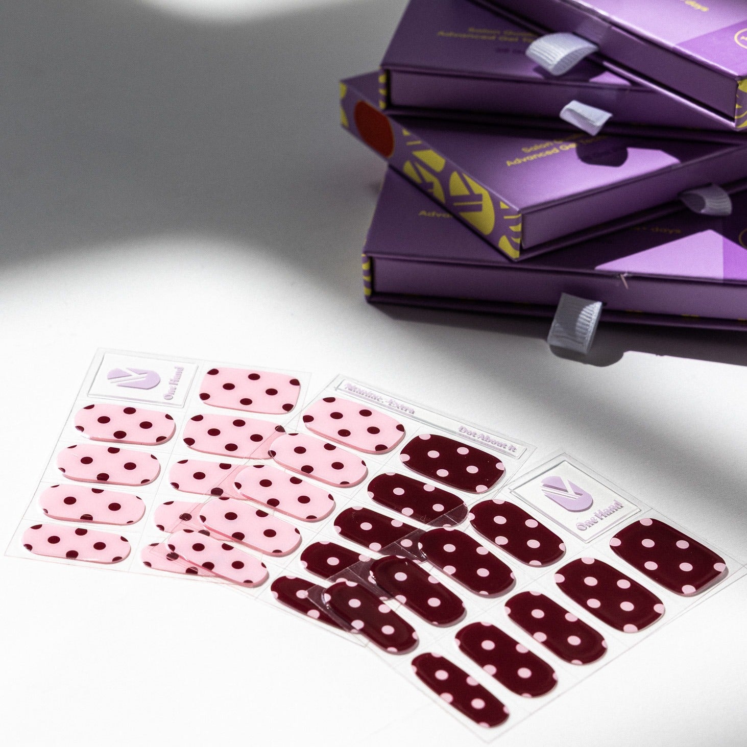 Dot About It gel nail sticker sheets by Maniac Nails, pink and bordeaux polka dot nail wraps and packaging