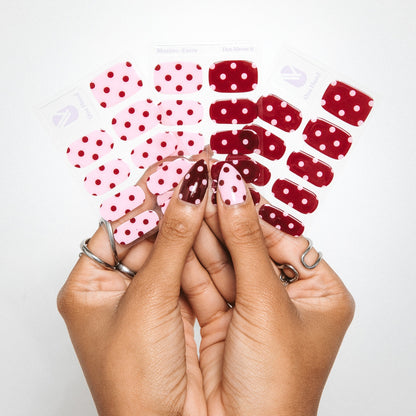 Hands holding Dot About It gel nail sticker sheets by Maniac Nails, polka dot nail wraps