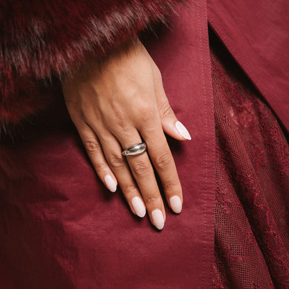 Family First Maniac Nails Anna Nooshin design light pink on hand with rink and dark red clothing 