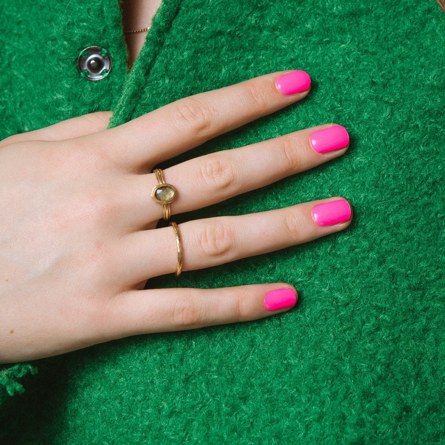 Gaga Pink Maniac nails bright pink gel stickers on hand with green jacket 