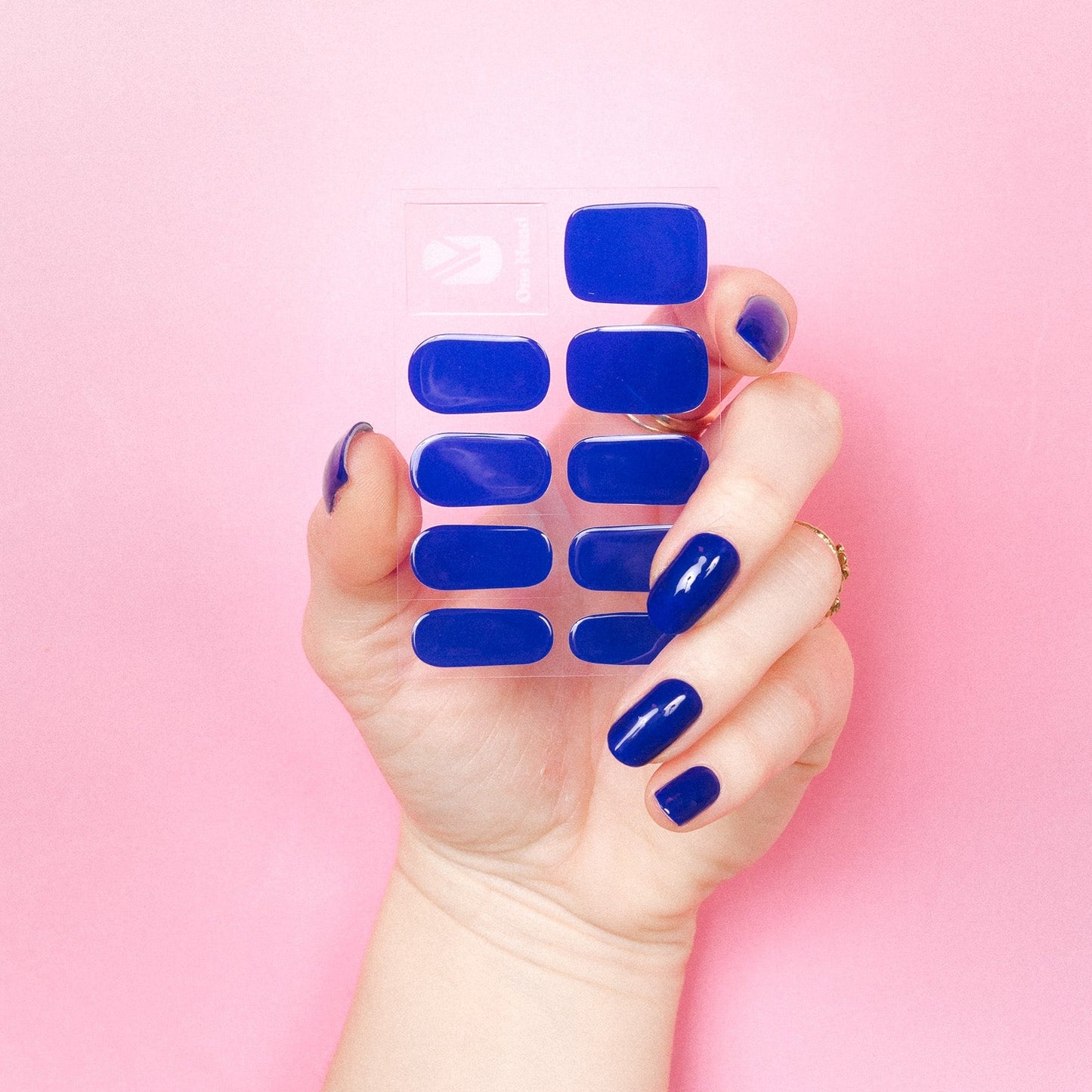 Maxima Blue Maniac Nails royal blue gel stickers on sheet and hand 