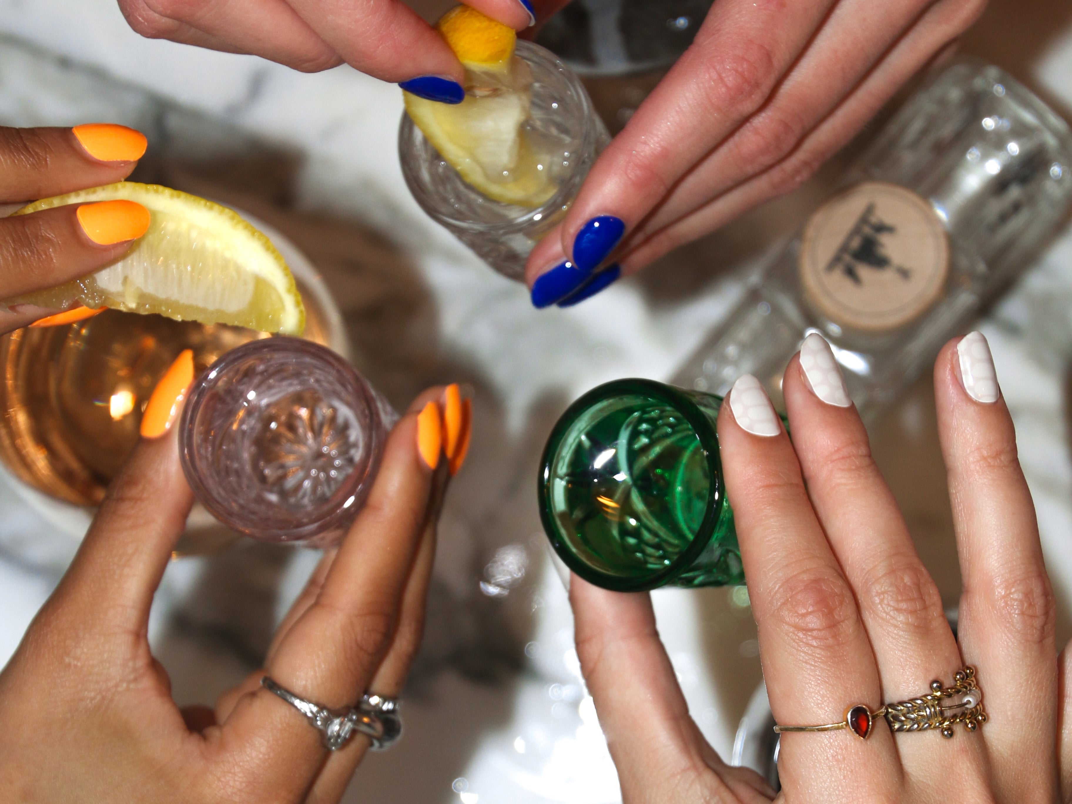 Hands celebrating with Oprah Orange, Blue and White Maniac Nail Gel Polish Stickers