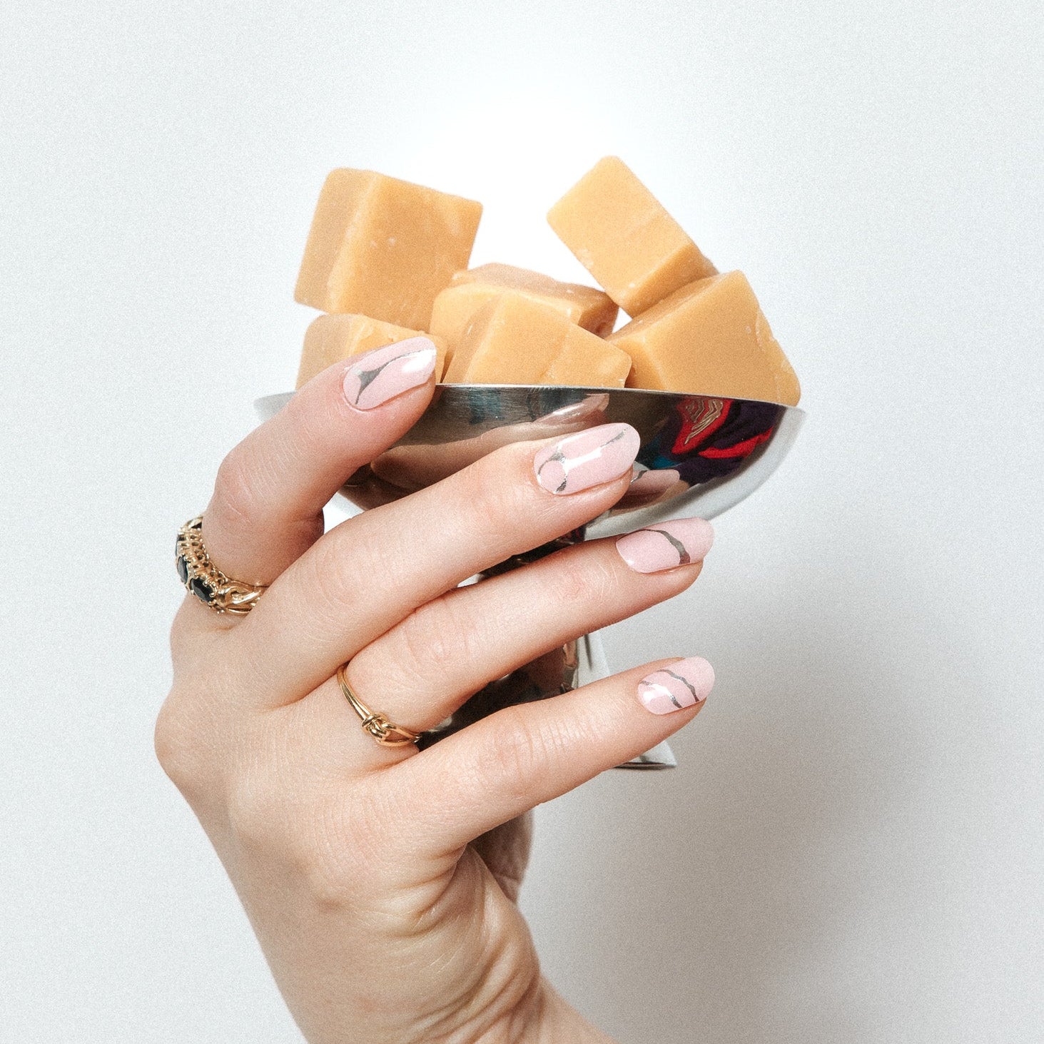 Silverline Bliss Maniac Nails light pink with silver marble cracks/lines nail art design stickers on hand with carmel cubes in cup