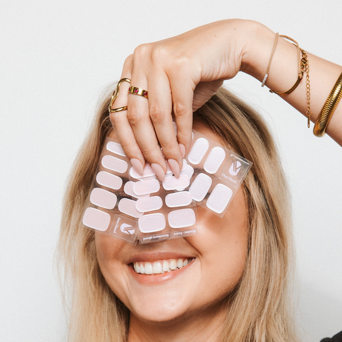 Model with Strawberry Glaze gel nail sticker sheets by Maniac Nails, milky pink nail wraps