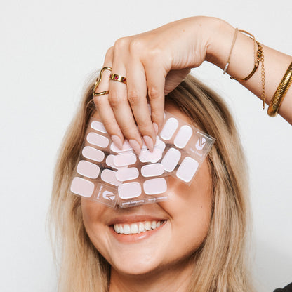 Model with Strawberry Glaze gel nail sticker sheets by Maniac Nails, milky pink nail wraps