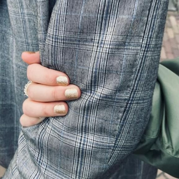 Close-up of Unstoppable gold glitter gel nail stickers by Maniac Nails