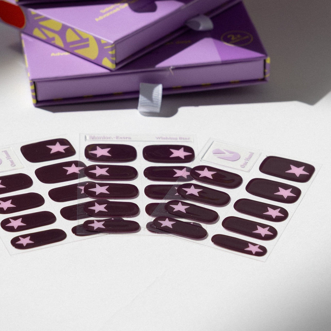 Wishing Star gel nail sticker sheets by Maniac Nails, plum nail wraps with stars and packaging