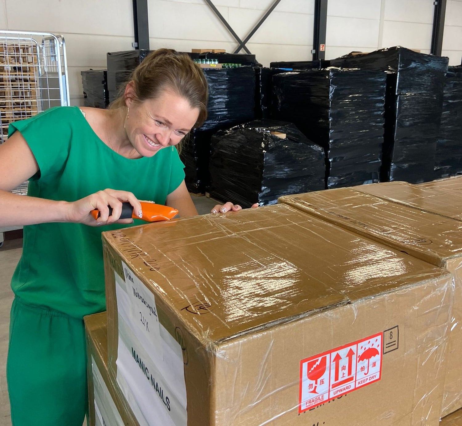 Maniac Nails founder Marlot Meddens checking product boxes in the warehouse
